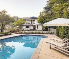  ??  ?? The two-story home features a concrete patio and pool.