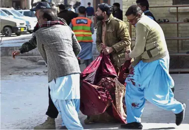  ?? — AP ?? Coming to aid:
A paramilita­ry soldier and volunteers rescuing an injured woman following the suicide attack on the church in Quetta, Pakistan.