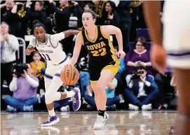  ?? Nam Y. Huh/Associated Press ?? Iowa guard Caitlin Clark (22) drives past Northweste­rn guard Hailey Weaver during the first half in Evanston, Ill., on Wednesday.