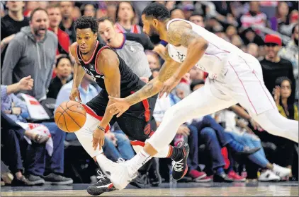  ?? AP PHOTO ?? Toronto Raptors’ Kyle Lowry, left, chases the ball against Washington Wizards’ Markieff Morris during NBA playoff action Sunday in Washington.