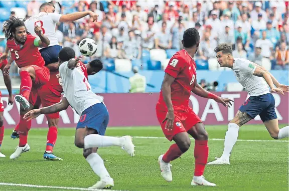  ?? Picture: Getty. ?? England defender John Stones, right, scores from a corner kick in the 6-0 thrashing of Panama in Nizhny Novgorod.