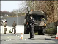  ?? (AP/PA/Matt Keeble) ?? Police and bomb disposal experts stand near St Michael Avenue, where residents had been evacuated and a cordon put in place after the discovery of a suspected World War II explosive device, Friday in Plymouth, England.