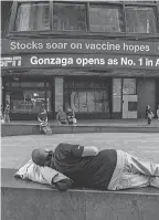  ?? DAVID DEE DELGADO/ GETTY IMAGES ?? An electronic billboard in Times Square announces “stocks soar on vaccine hopes” Monday in New York City.