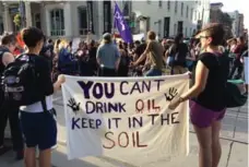  ?? ALICJA SIEKIERSKA/TORONTO STAR ?? Protesters hold a sign showing their disapprova­l of the U.S. plan to build a pipeline that will affect the Standing Rock Sioux tribe.