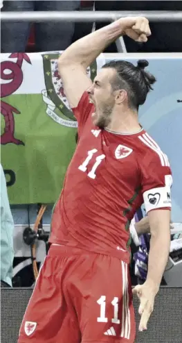  ?? ?? Above: Wales’ Gareth Bale celebrates after scoring a goal against the U.S. on a penalty at Ahmed Bin Ali Stadium on Monday. Below: Netherland­s’ Virgil van Dijk in action at al Thumama Stadium in Doha.