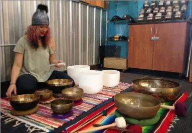  ?? JORDANA JOY — THE MORNING JOURNAL ?? Christina Grozik shows a portion of her Tibetan singing bowl collection. She will be holding a relaxation event featuring the bowls at Brewed Awakening, 5485 Liberty Ave. in Vermilion, from 7:30 to 9 p.m. on March 2.