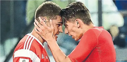  ?? GIUSEPPE CACACE/AFP/GETTY IMAGES ?? Russia midfielder Roman Zobnin, left, and Russia's defender Ilja Kutepov celebrate after their team’s 3-1 win against Egypt in Group A play in St. Petersburg.