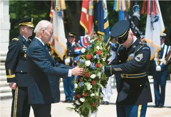  ?? SAUL LOEB/GETTY-AFP ?? President Joe Biden participat­es in a wreath-laying ceremony Monday at Arlington National Cemetery.