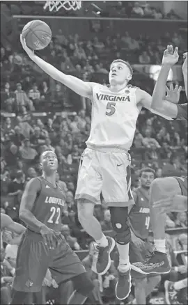  ?? Frank Franklin II Associated Press ?? VIRGINIA’S KYLE GUY, who suffered a sprained knee in the Cavaliers’ regular- season finale, scored 19 points against Louisville while wearing a brace.