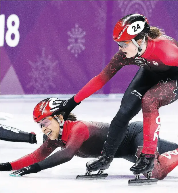  ?? NATHAN DENETTE / THE CANADIAN PRESS ?? Valérie Maltais falls as teammate Kim Boutin tries to help her as they compete in the women’s 3,000m short track speed skating relay.