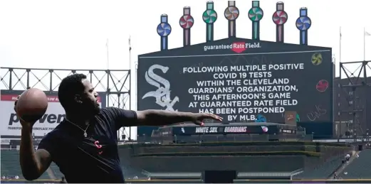  ?? CHARLES REX ARBOGAST/AP ?? The Guardians’ Franmil Reyes throws a football Wednesday at Guaranteed Rate Field after the game against the White Sox was postponed.