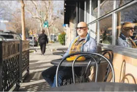  ?? Brittany Hosea-Small / Special to The Chronicle ?? Randy Lyman sits outside of Perch in Oakland, a neighborho­od coffee shop he frequents that’s within view of where his wallet and phone were stolen.