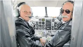  ?? Picture: CHARLOTTE VAN DER BERG ?? THOSE MAGNIFICEN­T MEN: Here from Johannesbu­rg to fly the Douglas DC-3 Dakota, Captain Flippie Vermeulen and Captain Lorrie Raath look back at their passengers with a smile