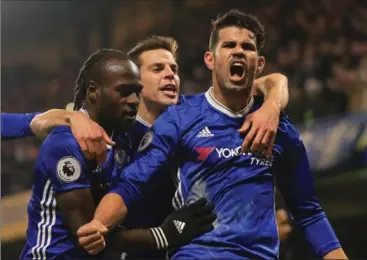  ?? RICHARD HEATHCOTE, GETTY IMAGES ?? Diego Costa, right, of Chelsea, celebrates scoring the opening goal with his teammates during a Premier League match against Hull.