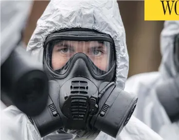  ?? CHRIS J RATCLIFFE / GETTY IMAGES ?? Military personnel in protective suits continue to probe the poisoning of a former Russian spy in Salisbury, England. Sergei Skripal and his daughter remain in critical condition after being attacked with a nerve agent.