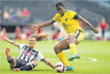  ?? AP ?? Jamaica’s Khadija Shaw (right) controls the ball as Costa Rica’s Fabiola Villalobos slides in during the Concacaf Women’s Championsh­ip match for third place in Monterrey, Mexico on Monday night. Jamaica won 1-0 in extra time to take third spot.