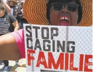  ?? Robyn Beck / AFP / Getty Images ?? A protester rallies against immigratio­n policy Saturday outside a detention center in San Diego.