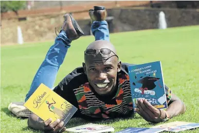  ?? /SUPPLIED ?? Mafule Moswane with the two books that he has written to help matrics.