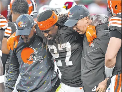  ?? David Richard The Associated Press ?? Browns running back Kareem Hunt is helped off the field after an injury during the second half against the Arizona Cardinals on Sunday in Cleveland.