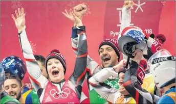  ?? CP PHOTO ?? Canadian lugers Alex Gough, Sam Edney, Tristan Walker and Justin Snith celebrate their team’s silver medal.