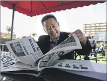  ?? Jason Armond Los Angeles Times ?? T.C. KIM, on the roof of California Marketplac­e, sits in the same spot where he photograph­ed armed Korean Americans.