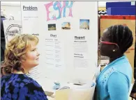  ?? NEWS FILE PHOTO ?? Patty Rooks of Praxis listens to Grade 5 student Aowen Kuthping explain her research project on Egypt at a science fair last year. Praxis celebrates 25 years helping teachers teach better science in southeast Alberta at Medicine Hat College on Friday.