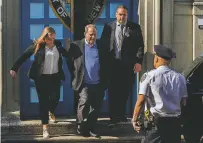  ?? ANDRES KUDACKI/THE ASSOCIATED PRESS ?? A handcuffed Harvey Weinstein, center, leaves the first precinct of the New York City Police Department after turning himself in Friday to authoritie­s.