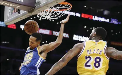  ??  ?? LOS ANGELES: Golden State Warriors guard Shaun Livingston (34) dunks against Los Angeles Lakers center Tarik Black (28) during the first half of an NBA basketball game in Los Angeles, Friday. — AP