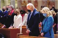  ?? EVAN VUCCI/AP ?? President Joe Biden and his wife, Jill Biden, celebrate Mass at the Cathedral of St. Matthew the Apostle during Inaugurati­on Day ceremonies in January in Washington.