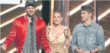  ??  ?? Alex Pall and Andrew Taggart of The Chainsmoke­rs flank Halsey onstage during the 2017 Billboard Music Awards in Las Vegas.