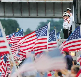  ?? JOHN BAZEMORE/ THE ASSOCIATED PRESS ?? Firefighte­rs stand at attention as a procession carrying the remains of Lance Cpl. Squire ‘ Skip’ Wells approaches an overpass on I- 75 in Marietta, Ga., on Thursday. Wells was one of four Marines and a sailor who were fatally shot during an attack on...