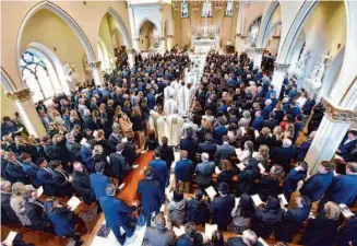  ?? Todd McInturf/Associated Press ?? The casket of Michigan State shooting victim Brian Fraser proceeds into St. Paul on the Lake Catholic Church during his funeral mass Saturday in Grosse Pointe Farms, Mich.