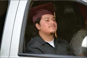  ?? RECORDER PHOTOS BY ALEXIS ESPINOZA ?? Jakob Bosquez was one of the first graduates to receive their diploma on Friday night during the Citrus High School drive-thru graduation ceremony.