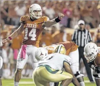  ?? JAY JANNER / AMERICAN-STATESMAN ?? Quarterbac­k David Ash started the first 11 games of the season, but a rib injury against TCU sidelined him for the regular-season finale at Kansas State. Ash was 8-3 in those games.