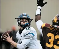  ?? ROB DICKER/DAILY SOUTHTOWN ?? Lincoln-Way East’s Jack Baltz looks for a receiver as Loyola’s Armoni Dixon applies pressure during a Class 8A semifinal on Saturday.