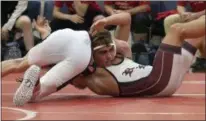  ?? JEN FORBUS — FOR THE MORNING JOURNAL ?? Rocky River’s Josh Bergin tries to get out from under Lutheran West’s Robert Pinkie during their bout at 132 pounds on Dec. 10.