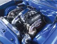  ??  ?? ENGINE BAY: The big-inch iron-block LSX wears deep-breathing, six-bolt, square-port heads, which drag compressed air in from an Ls7-style single-plane intake manifold. On top of the intake is a custom elbow and 102mm electronic throttlebo­dy, connected to the Precision turbos via an air-to-air intercoole­r