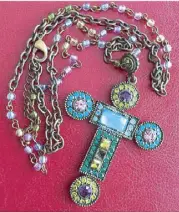  ??  ?? From Russia with love: A multi-colored cross with a necklace of beads from Pitoy