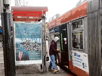  ?? Carl Nolte/The Chronicle ?? Riders board a 14-Mission bus, one of Muni’s more popular lines, from the back door. Many of today’s buses and rail cars are cleaner, with less graffiti.