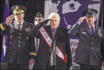  ?? Andres Kudacki The Associated Press ?? Former astronaut Buzz Aldrin, center, salutes Saturday during the annual Veterans Day parade in New York. Aldrin served as grand marshal and joined Mayor Bill de Blasio and others at the parade.
