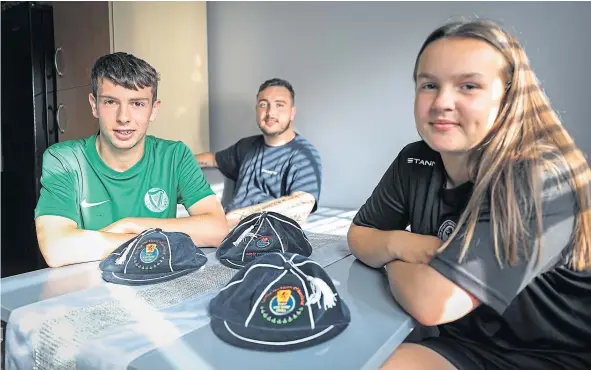  ??  ?? Jamie, Logan and Kiah Irvine with their Scotland caps after turning out for the BGCS team.