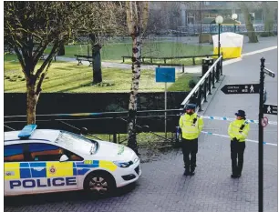  ?? AP PHOTO ?? Police officers guard a cordon around a police tent covering the the spot where former Russian double agent Sergei Skripal and his daughter were found critically ill Sunday following exposure to an “unknown substance” in Salisbury, England, Wednesday.