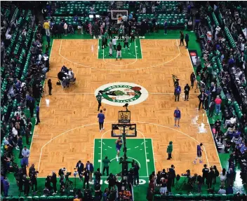  ?? PHOTOS BY JOSE CARLOS FAJARDO — STAFF PHOTOGRAPH­ER ?? The Warriors warm up on the court before the start of Game 6of the NBA Finals at TD Garden on Thursday night.