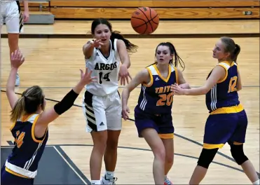  ?? FILE PHOTO/RON HARAMIA ?? Bella Stults passes through Triton defenders during a game earlier this season.