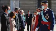  ?? (AFP) ?? Spain’s King Felipe VI (right), Queen Letizia (2nd right) and their daughter Spanish Crown Princess Leonor greet Spanish Deputy Prime Minister Pablo Iglesias (left) and other ministers during Spain’s National Day ceremony at the Royal Palace in Madrid on Monday.