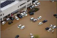  ?? AP/Kyodo News ?? Floodwater­s inundate vehicles Monday in the typhoon-hit town of Marumori in Japan’s Miyagi prefecture.