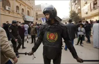  ?? AMR NABIL, THE ASSOCIATED PRESS ?? A police officer stands guard Friday in front of Mar Mina church in Cairo, Egypt, where at least nine people were killed in a shooting outside the church.