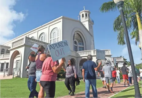  ?? FRANK SAN NICOLAS, PACIFIC DAILY NEWS ?? Members and supporters of the Laity Forward Movement and the Concerned Catholics of Guam march in front of the Dulce Nombre de Maria Cathedral-Basilica in Hagåtña, Guam’s capital, in January. The church has long been the center of life on the island.