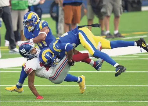  ?? Kyusung Gong / Associated Press ?? Los Angeles Rams cornerback Jalen Ramsey, right, tackles New York Giants wide receiver Golden Tate during Sunday’s game in Inglewood, Calif.