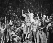  ?? ASSOCIATED PRESS FILE ?? North Carolina State’s Mark Noeller jumps into the air March 23, 1974, as they defeat UCLA, 80-77, in double overtime during a national semifinal in Greensboro, N.C.